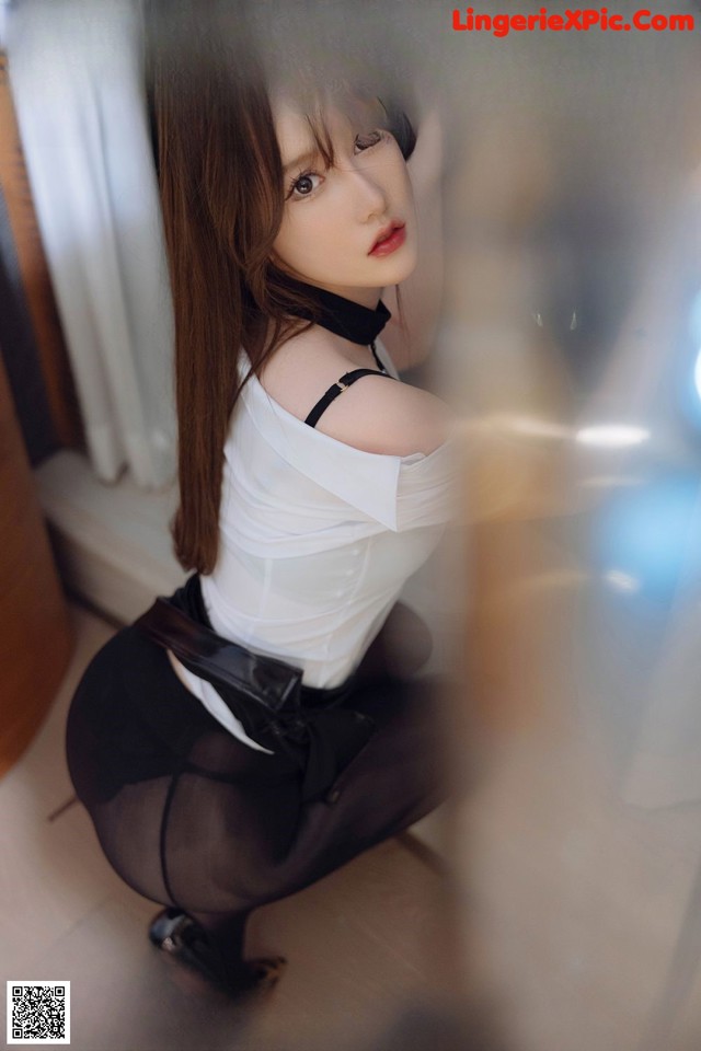 a woman in a white shirt and black skirt posing for a magazine