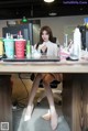 A woman sitting at a desk in an office.