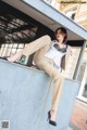 A woman sitting on top of a bus stop.