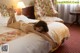 A woman laying on a bed in a hotel room.