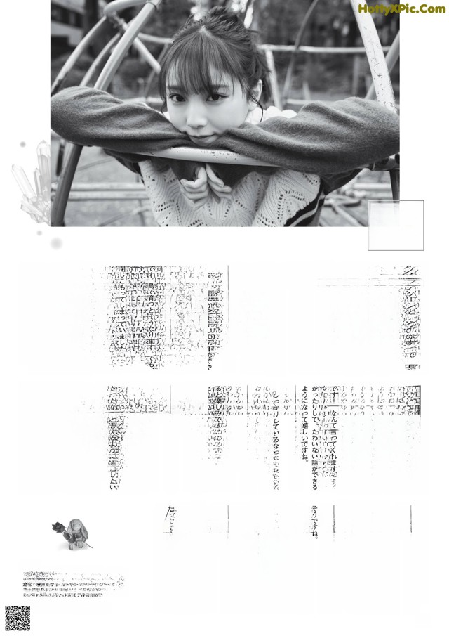 A black and white photo of a little girl wrapped in a blanket.