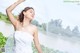 A woman in a wedding dress standing on a bridge.